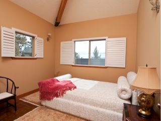 Cordless Roman Shade installed on a window with a city skyline in the background.